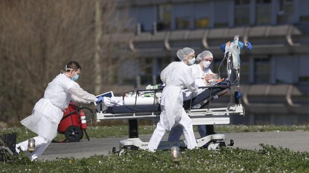 A victim of coronavirus is evacuated by stretcher from the Mulhouse civil hospital in eastern France. (AP Photo) A victim of coronavirus is evacuated by stretcher from the Mulhouse civil hospital in eastern France. (AP Photo)