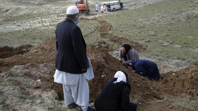 Relatives cry on the grave of coronavirus victim on the outskirts of Herat province west of Kabul, Afghanistan. (AP) Relatives cry on the grave of coronavirus victim on the outskirts of Herat province west of Kabul, Afghanistan. (AP)