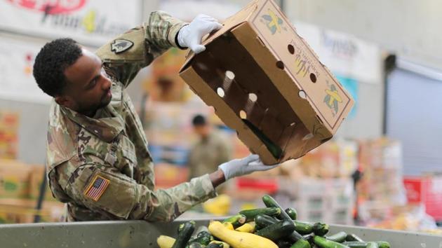California National Guard troops package food bags to assist elderly volunteer workers in home confinement in Indio, California. A number of hotels in New York City, including the Plaza Hotel, the St. Regis and the Four Seasons, are making rooms available to medical workers fearful of carrying the virus home to their families after work, or to non-critical care patients, New York Governor Andrew Cuomo said. (Lucy Nicholson / REUTERS) California National Guard troops package food bags to assist elderly volunteer workers in home confinement in Indio, California. A number of hotels in New York City, including the Plaza Hotel, the St. Regis and the Four Seasons, are making rooms available to medical workers fearful of carrying the virus home to their families after work, or to non-critical care patients, New York Governor Andrew Cuomo said. (Lucy Nicholson / REUTERS)