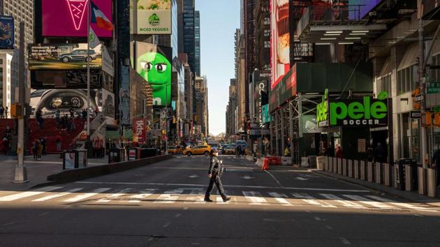 A police officer crosses the street in a nearly empty Times Square on March 12, 2020, New York, United States. (AFP) A police officer crosses the street in a nearly empty Times Square on March 12, 2020, New York, United States. (AFP)