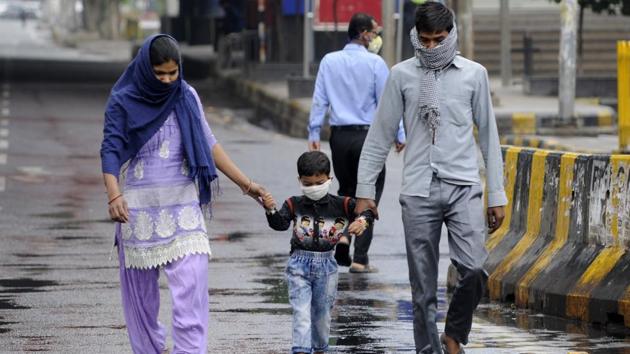 People with their faces covered with masks out in the rain, on day 3 of the three week nationwide lockdown to check the spread of coronavirus, at Sector 19, Noida. (Sunil Ghosh / Hindustan Times) People with their faces covered with masks out in the rain, on day 3 of the three week nationwide lockdown to check the spread of coronavirus, at Sector 19, Noida. (Sunil Ghosh / Hindustan Times)