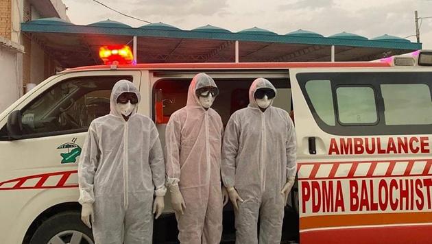 Pakistani medical staff stand at the Pakistan-Iran border, which was closed due to the outbreak of coronavirus in neighboring Iran, Tuesday, Feb. 25, 2020, in Taftan, Pakistan. Pakistan has closed its border with Iran after Tehran reported casualties from the deadly coronavirus, official said. (AP Photo/Arshad Butt)(AP)