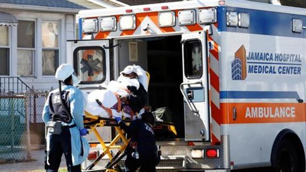 Emergency Medical Technicians (EMT) lift a patient into an ambulance while wearing protective gear as the outbreak of coronavirus disease continues in New York City, US. (REUTERS) Emergency Medical Technicians (EMT) lift a patient into an ambulance while wearing protective gear as the outbreak of coronavirus disease continues in New York City, US. (REUTERS)