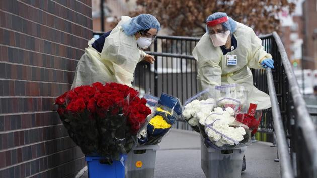 Coronavirus update: Emergency room nurses transport buckets of donated flowers up a ramp outside Elmhurst Hospital Center's emergency room in New York.(AP) Coronavirus update: Emergency room nurses transport buckets of donated flowers up a ramp outside Elmhurst Hospital Center's emergency room in New York.(AP)