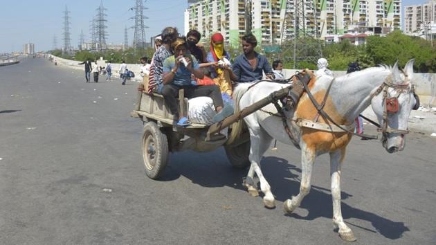Migrant workers head home on an animal cart in Ghaziabad, following the 21-day nationwide lockdown imposed by PM Modi in the wake of the coronavirus outbreak. (Sakib Ali / HT Photo) Migrant workers head home on an animal cart in Ghaziabad, following the 21-day nationwide lockdown imposed by PM Modi in the wake of the coronavirus outbreak. (Sakib Ali / HT Photo)