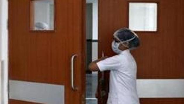 A paramedic staff member enters a newly setup isolation ward for the people who suffer symptoms of coronavirus disease (COVID-19), at a hospital in Kolkata.(REUTERS)
