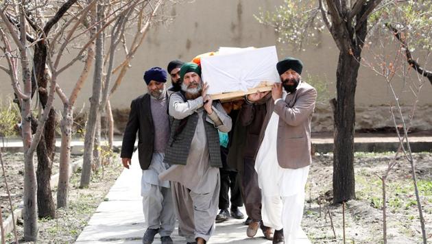 Afghan Sikh men carry a coffin of one of the victims who was killed during the attack at a Kabul gurdwara on March 25, 2020.(REUTERS)