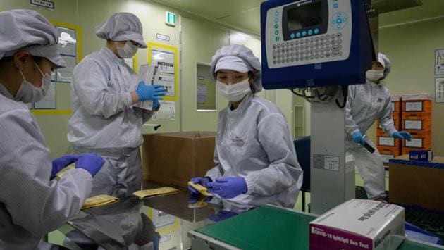 COVID-19 novel coronavirus testing kits are packaged on a production line. Speed was a key factor in the South’s rapid scaling-up of its testing programme -- a result of its painful experience in dealing with the 2015 Middle East Respiratory Syndrome outbreak, when 38 people died. (Ed Jones / AFP) 