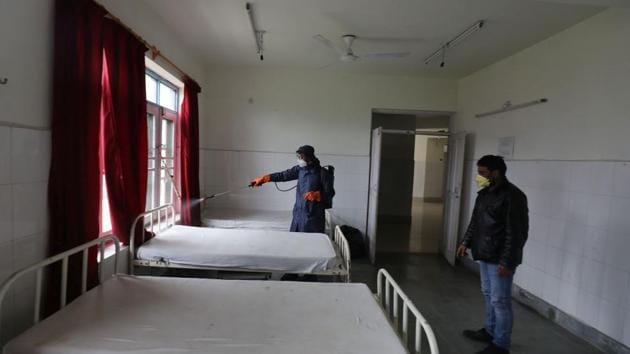 An employee of the Srinagar Municipal Corporation (SMC) sprays disinfectant at a hospital during sanitization on day 4 of the 21 day national lockdown to check the spread of coronavirus. (Waseem Andrabi/HT Photo) An employee of the Srinagar Municipal Corporation (SMC) sprays disinfectant at a hospital during sanitization on day 4 of the 21 day national lockdown to check the spread of coronavirus. (Waseem Andrabi/HT Photo)