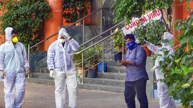 Medical staff members wear masks and protective suits to mitigate the spread of coronavirus.(PTI)