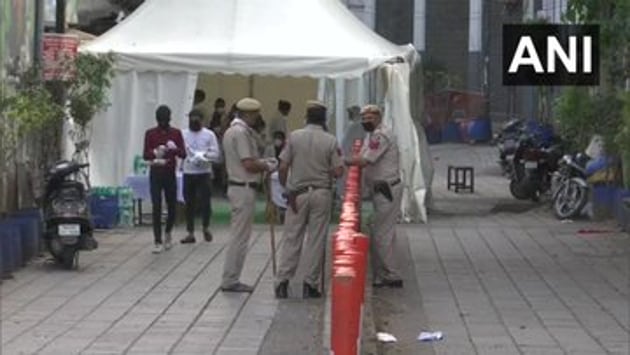 A Delhi Police team in Nizamuddin on Monday after several people in the area showed symptoms of coronavirus.(ANI)