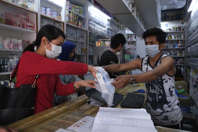 A girl buys surgical masks in Manipur’s capital Imphal. The north eastern state’s first Covid-19 patient tested negative on April 6, 2020, after treatment. (AP File) A girl buys surgical masks in Manipur’s capital Imphal. The north eastern state’s first Covid-19 patient tested negative on April 6, 2020, after treatment. (AP File)