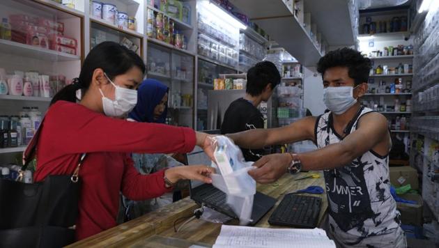 A woman buys surgical masks in Imphal, Manipur, March 20, 2020. The state reported its first Covid-19 case on March 24.(AP File) A woman buys surgical masks in Imphal, Manipur, March 20, 2020. The state reported its first Covid-19 case on March 24.(AP File)