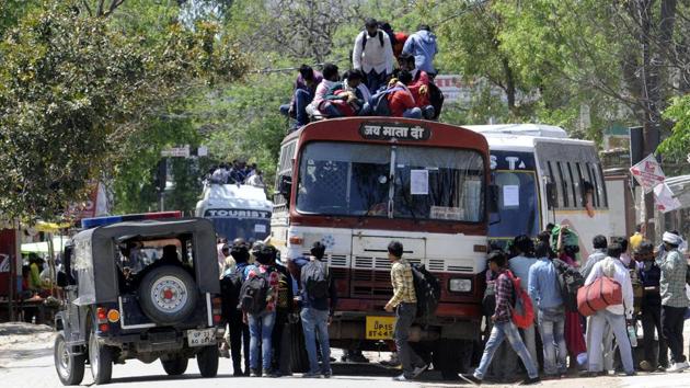 Migrant workers try to board an overcrowded bus to return to their home on Day 5 of the 21 day nationwide lockdown to curb the spread of coronavirus, at Asti Road, Bakshi Ka Talab, in Lucknow, on Sunday, March 29, 2020. (Dheeraj Dhawan / HT file photo) Migrant workers try to board an overcrowded bus to return to their home on Day 5 of the 21 day nationwide lockdown to curb the spread of coronavirus, at Asti Road, Bakshi Ka Talab, in Lucknow, on Sunday, March 29, 2020. (Dheeraj Dhawan / HT file photo)