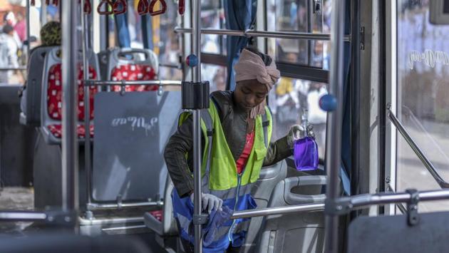 A volunteer disinfects a passenger bus in the capital Addis Ababa, Ethiopia. A large part of the global workforce has given up on daily commutes, working remotely from their homes to control the spread of the virus. The UN for instance has 99% of its staff  in Addis Ababa working from home. (Mulugeta Ayene / AP) 