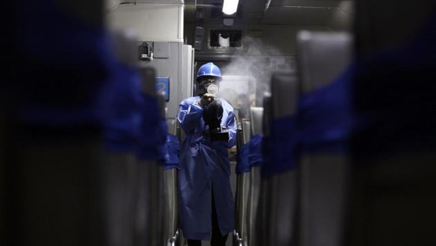 A worker in a protective suit walks through passenger car spraying disinfectant n Medan, Indonesia. For countries where commuters are still stepping out, frontline workers are engaged in regular sanitization. (Binsar Bakkara / AP) 
