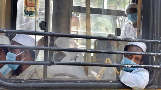 People wearing masks board a bus that will take them to a quarantine facility and hospitals after they showed signs of Covid-19 disease post taking part in a religious gathering in Delhi’s Nizamuddin area in New Delhi, on Tuesday, March 31, 2020. (Photo by Ajay Aggarwal/ Hindustan Times)