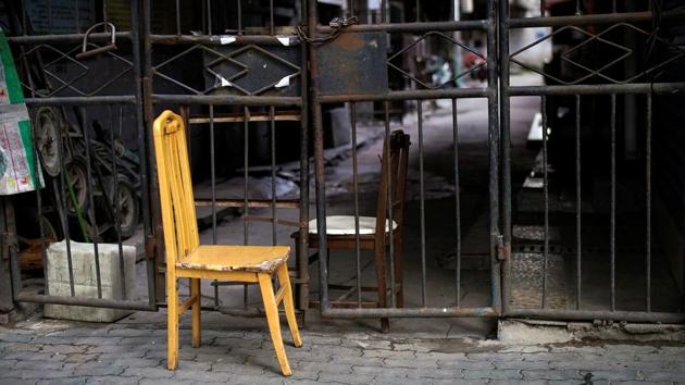 Two chairs are pictured at a closed entrance of a residential community is seen in Wuhan. The existence of an unknown number of asymptomatic carriers of coronavirus in China has raised concerns among the public that lifting the restrictions may release thousands of people who could still be unknowingly spreading the virus that causes COVID-19. (Aly Song / REUTERS)