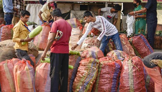 Locals buy vegetables, supplied by Assam Food Supply Department, during a nationwide lockdown, imposed in the wake of coronavirus pandemic, at Ganeshguri in Guwahati, Saturday, March 28, 2020.(PTI photo)