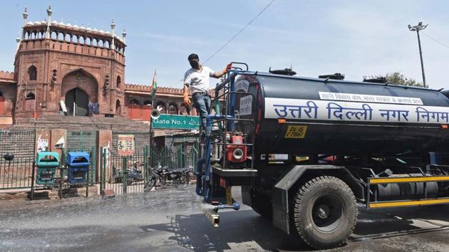 MCD workers spray chemical disinfectants on the street during a sanitization drive at Jama Masjid in Delhi. (Sanchit Khanna / HT Photo) MCD workers spray chemical disinfectants on the street during a sanitization drive at Jama Masjid in Delhi. (Sanchit Khanna / HT Photo)