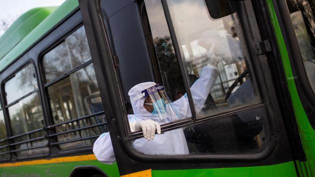 A driver wearing a protective suit climbs a bus used for transporting suspected carriers of coronavirus to a quarantine facility amid concerns about the spread of coronavirus disease (COVID-19), in Nizamuddin area of New Delhi.(REUTERS) A driver wearing a protective suit climbs a bus used for transporting suspected carriers of coronavirus to a quarantine facility amid concerns about the spread of coronavirus disease (COVID-19), in Nizamuddin area of New Delhi.(REUTERS)