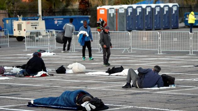 Homeless people get settled in a temporary parking lot shelter, with spaces marked for social distancing to help slow the spread of coronavirus disease Covid-19 in Las Vegas, on March 30.(Reuters Photo)