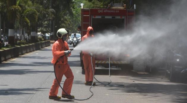 Mumbai fire brigade personnel sanitize area Machimar Colony in Colaba area to check the spread of coronavirus.(Bhushan Koyande/ HT PHOTO)