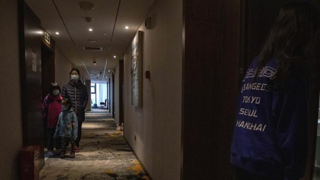 Quarantined returnees queue up for a COVID-19 test at a quarantine hotel in Wuhan in central China's Hubei province on Tuesday, March 31, 2020. China on Tuesday reported just one new death from the coronavirus and just a few dozen new cases, claiming that all new cases came from overseas. (AP) Quarantined returnees queue up for a COVID-19 test at a quarantine hotel in Wuhan in central China's Hubei province on Tuesday, March 31, 2020. China on Tuesday reported just one new death from the coronavirus and just a few dozen new cases, claiming that all new cases came from overseas. (AP)