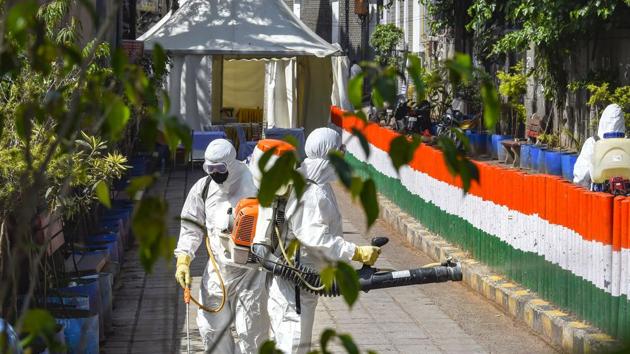 Health workers sanitise the area in Nizamuddin, after people who attended the religious congregation at a markaz there tested positive for Covid-19, in New Delhi on April 1. (PTI Photo) Health workers sanitise the area in Nizamuddin, after people who attended the religious congregation at a markaz there tested positive for Covid-19, in New Delhi on April 1. (PTI Photo)