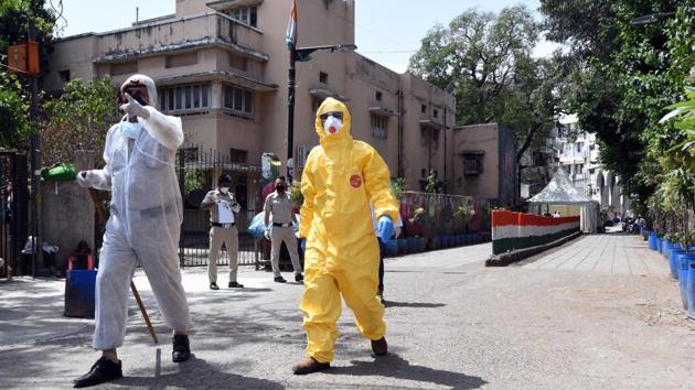 As many as 40 masked domestic breeding checkers (DBCs) are spraying disinfectant in the narrow alleys and lanes in the area that tankers cannot enter. (Ajay Aggarwal/HT photo) As many as 40 masked domestic breeding checkers (DBCs) are spraying disinfectant in the narrow alleys and lanes in the area that tankers cannot enter. (Ajay Aggarwal/HT photo)