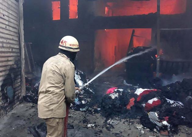 A firefighter trying to control the blaze at the knitwear factory on Bahadur Ke Road in Ludhiana on Wednesday. (Gurpreet Singh/HT) A firefighter trying to control the blaze at the knitwear factory on Bahadur Ke Road in Ludhiana on Wednesday. (Gurpreet Singh/HT)