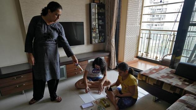 Meghna Dani, 43, who works as a teacher, helps her daughters Naisha Dani, 13, and Saisha Dani, 9, paint at their home, in Mumbai. The lockdown has presented an unforeseen challenge to schools, with only a select few able to provide online classroom sessions to their students. (Hemanshi Kamani / REUTERS)