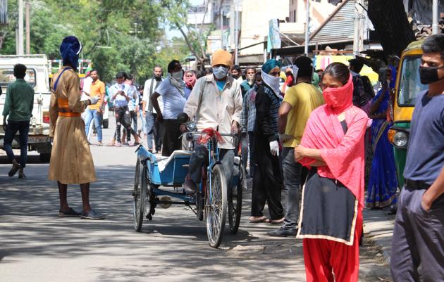 Residents gathered during ration distribution amid curfew at Mohali village on Wednesday. (Gurminder Singh/HT) Residents gathered during ration distribution amid curfew at Mohali village on Wednesday. (Gurminder Singh/HT)
