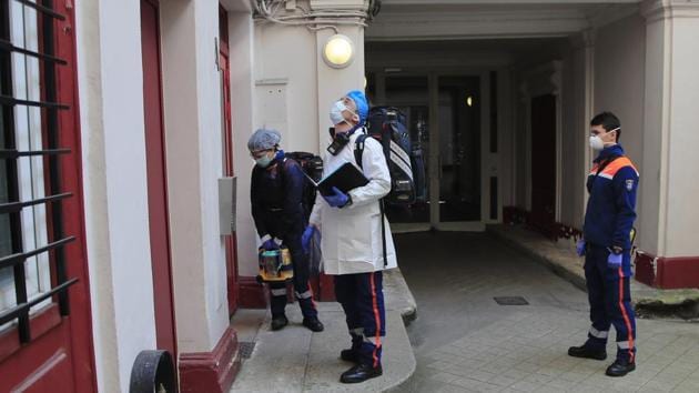 Members of the Civil Protection service, Noemie Biamba (L), Cyril Lamriben (C), and Pierre Leroux wait outside a possibly infected woman’s home. The service is a mainstay among France's first responder sector with 32,000 volunteers based in 400 locations around the country. (Michel Euler / AP) Members of the Civil Protection service, Noemie Biamba (L), Cyril Lamriben (C), and Pierre Leroux wait outside a possibly infected woman’s home. The service is a mainstay among France's first responder sector with 32,000 volunteers based in 400 locations around the country. (Michel Euler / AP)