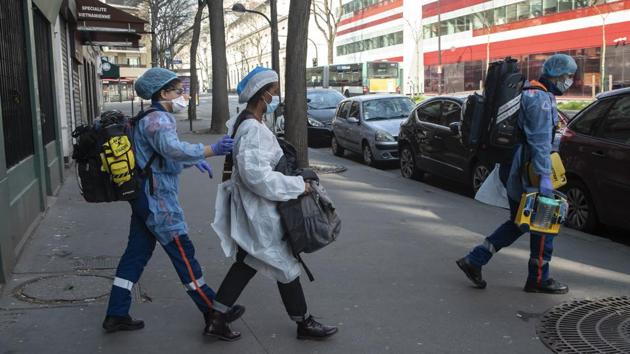 A woman is escorted to a Civil Protection service ambulance. The Paris teams start their missions at Necker Children’s Hospital, where they gear up. They return there to get rid of their garb and disinfect after each intervention. “What is striking is that all our interventions concern coronavirus,” Lejeune said, either respiratory distress or other signs of COVID-19. “This is how we see the size of the coronovirus in Paris. It’s ramping up.” (Michel Euler / AP) A woman is escorted to a Civil Protection service ambulance. The Paris teams start their missions at Necker Children’s Hospital, where they gear up. They return there to get rid of their garb and disinfect after each intervention. “What is striking is that all our interventions concern coronavirus,” Lejeune said, either respiratory distress or other signs of COVID-19. “This is how we see the size of the coronovirus in Paris. It’s ramping up.” (Michel Euler / AP)