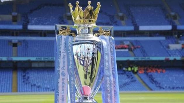 he English Premier League trophy sits on the pitch. (T) he English Premier League trophy sits on the pitch. (T)