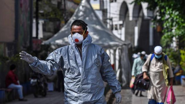 A government personnel in a protective suit at the spot where people who took part in a Tablighi Jamaat function earlier this month. (Biplov Bhuyan/HT PHOTO) A government personnel in a protective suit at the spot where people who took part in a Tablighi Jamaat function earlier this month. (Biplov Bhuyan/HT PHOTO)
