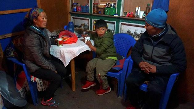 Phurba Nyamgal Sherpa (R) with his family at home. Ropes and picks are still hung up in the Khumjung houses with their green stone roofs. Hostels and tea shops in the region used by trekkers and climbers acclimatising for the start of the 8,848-metre (29,029 feet) ascension are empty. Nepal suspended permits for all mountain expeditions on March 12, effectively closing its peaks. (Prakash Mathema / AFP)