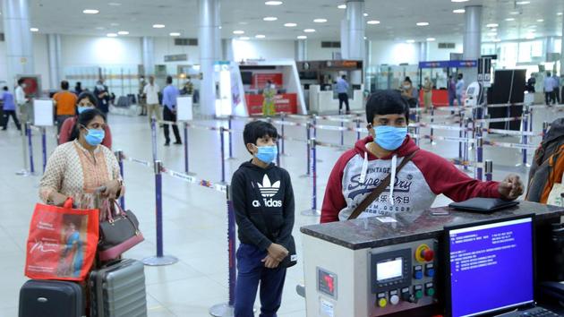 Passengers standing at the counter wearing masks and maintaining social distancing at the airport in Hyderabad on March 31. (ANI Photo) Passengers standing at the counter wearing masks and maintaining social distancing at the airport in Hyderabad on March 31. (ANI Photo)