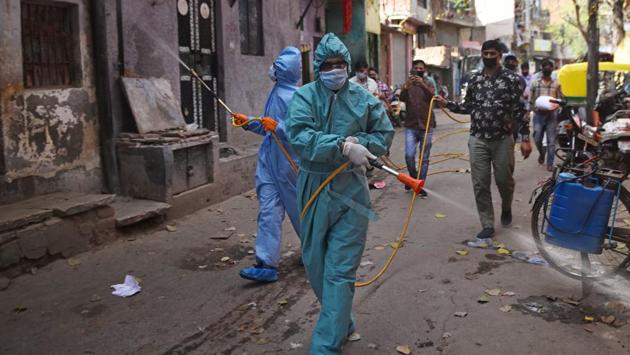 Wearing PPE suits and seen sanitizing a lane in Anand Parbat, sanitation employees are in full force across the city. There are around 71,345 sanitation workers engaged with three municipal corporations — North Delhi Municipal Corporation, EDMC and SDMC. (Sanchit Khanna / HT PHOTO) Wearing PPE suits and seen sanitizing a lane in Anand Parbat, sanitation employees are in full force across the city. There are around 71,345 sanitation workers engaged with three municipal corporations — North Delhi Municipal Corporation, EDMC and SDMC. (Sanchit Khanna / HT PHOTO)