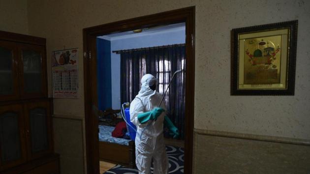 Delhi Government public health department workers in PPE suits disinfect local resident's residence during a sanitization drive amid concerns of infection. (Biplov Bhuyan/HT PHOTO) Delhi Government public health department workers in PPE suits disinfect local resident's residence during a sanitization drive amid concerns of infection. (Biplov Bhuyan/HT PHOTO)