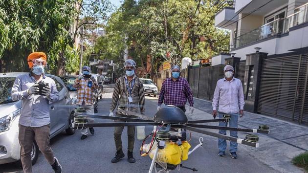 Drones being used by municipal employees to spray disinfectant during a sanitisation drive. (Biplov Bhuyan/HT PHOTO) Drones being used by municipal employees to spray disinfectant during a sanitisation drive. (Biplov Bhuyan/HT PHOTO)
