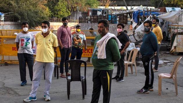 Residents stand guard next to the barricades which they have used for blocking the road connecting to Nizamuddin area where hundreds were taken away to be quarantined amid coronavirus disease Covid-19 fears, in New Delhi on April 1. (Reuters Photo) Residents stand guard next to the barricades which they have used for blocking the road connecting to Nizamuddin area where hundreds were taken away to be quarantined amid coronavirus disease Covid-19 fears, in New Delhi on April 1. (Reuters Photo)