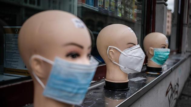 Various protective face masks, worn by many people during the coronavirus pandemic, are on display for sale outside a shop in Berlin, April 2, 2020(AFP)
