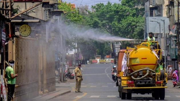 PMC workers disinfect area near Dagdusheth Halwai temple in Pune. (HT PHOTO/Sanket Wankhade) PMC workers disinfect area near Dagdusheth Halwai temple in Pune. (HT PHOTO/Sanket Wankhade)