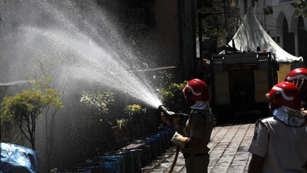 Delhi fire officers disinfect an area at Nizamuddin, from where several people who attended an Islamic congregation earlier this month were tested positive for Covid-19, in New Delhi, on Thursday. (AP) Delhi fire officers disinfect an area at Nizamuddin, from where several people who attended an Islamic congregation earlier this month were tested positive for Covid-19, in New Delhi, on Thursday. (AP)
