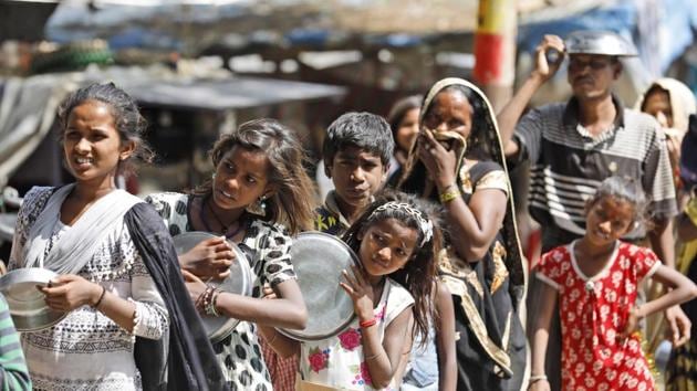 Impoverished Indians receive food distributed by a Hindu religious organization in Prayagraj, India. At least 200 million poor women will get the remittance under the scheme between April 3 and April 9. (AP) Impoverished Indians receive food distributed by a Hindu religious organization in Prayagraj, India. At least 200 million poor women will get the remittance under the scheme between April 3 and April 9. (AP)