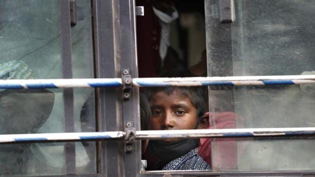The son of a migrant daily wage laborer looks out a bus window bus as he travels to his hometown following a lockdown amid concern over spread of coronavirus in New Delhi.(AP)