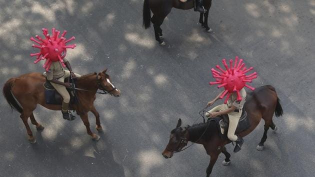 Policeman wearing virus themed helmets ride on horses during an awareness rally aimed at preventing the spread of new coronavirus in Hyderabad. (AP) Policeman wearing virus themed helmets ride on horses during an awareness rally aimed at preventing the spread of new coronavirus in Hyderabad. (AP)