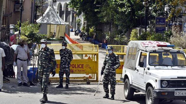 Paramilitary personnel accompany police at the cordoned off entry route to the Tablighi Jamaat’s Alami Markaz Banglewali Masjid building, on day eleven of the 21-day nationwide lockdown to check the spread of coronavirus, at Nizamuddin in New Delhi on April 4, 2020.(Sanjeev Verma/HT PHOTO)